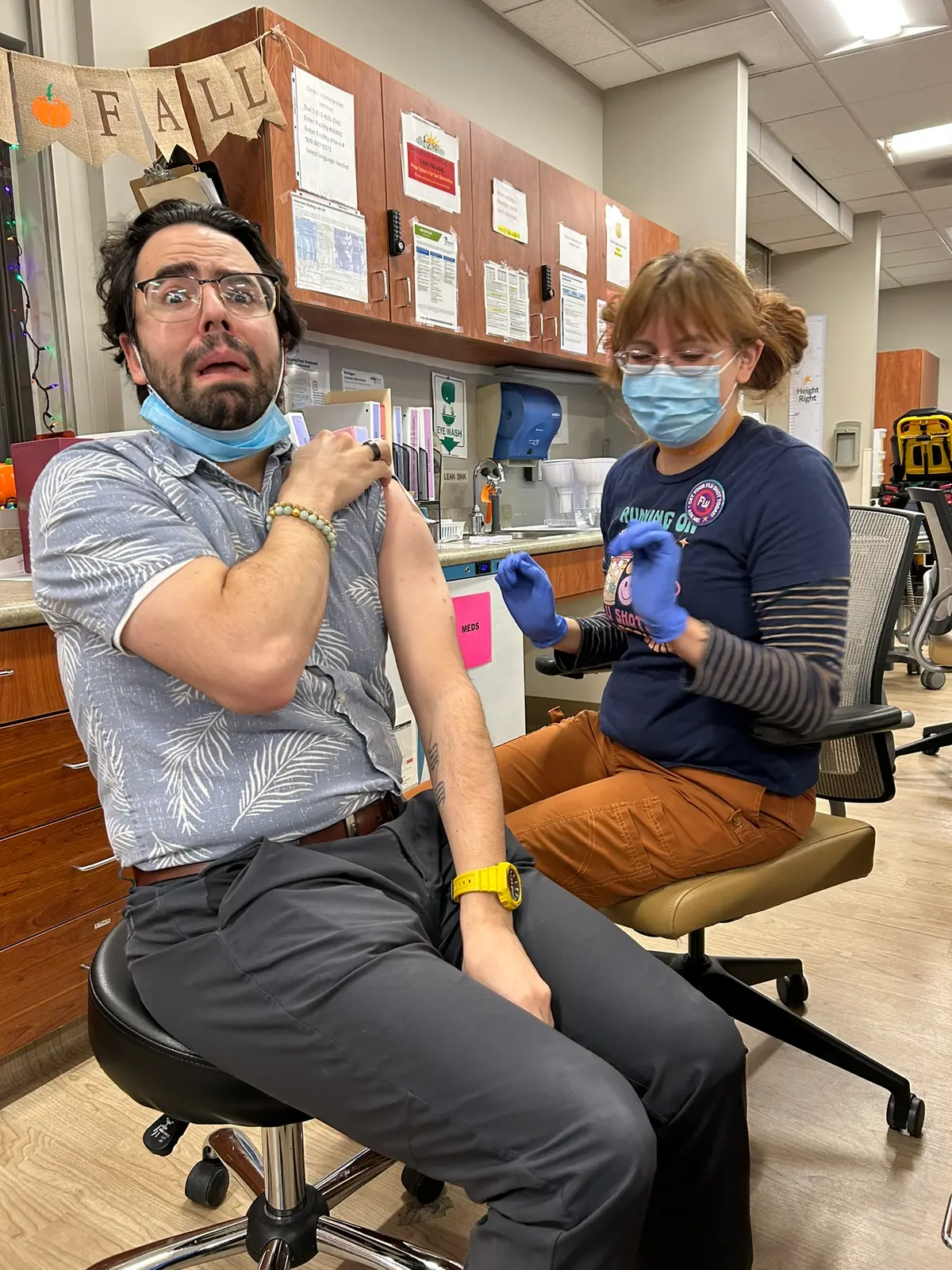 Ale Eguren getting a flu shot from a nurse during a clinic flu campaign